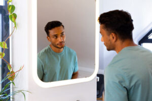 Man looking at himself in a mirror.