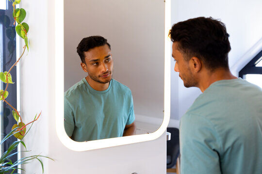 Man looking at himself in a mirror.