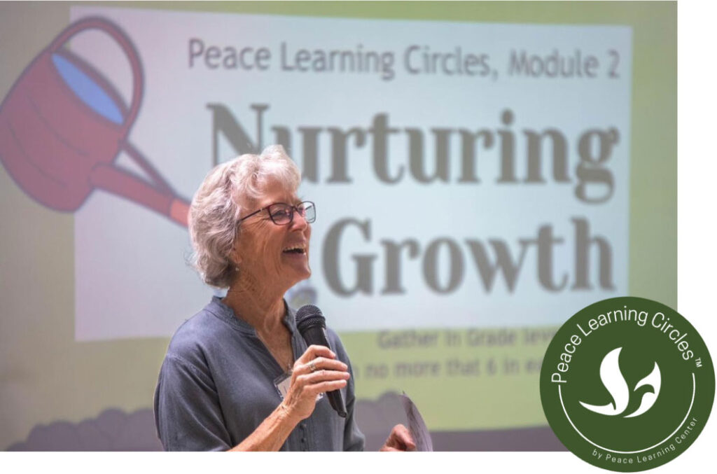 Woman speaking into microphone while presenting Peace Learning Circles, Module 2