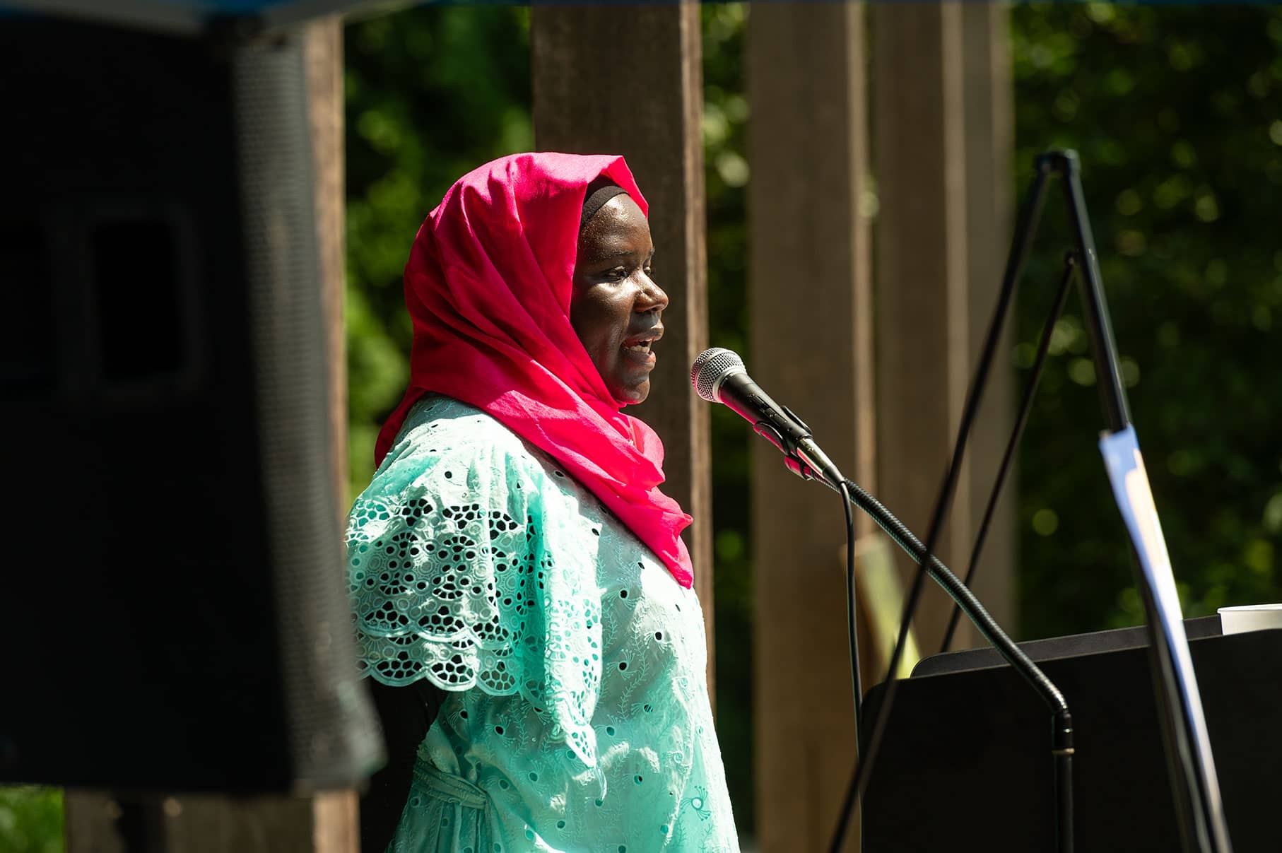 Woman speaking into microphone at a podium