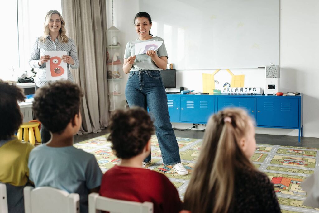 Teachers talking to students in a classroom