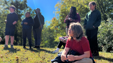 Group of kids sitting outside.